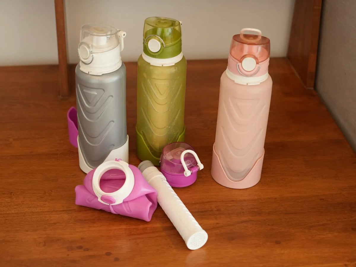 Three Fllexibott bottles, a folded bottle and the white filter cartridge