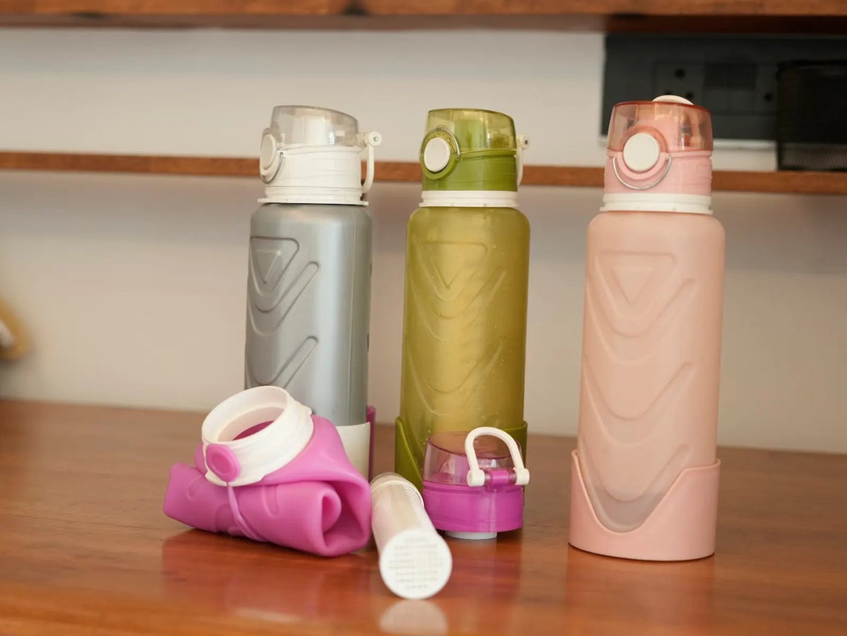 Fllexibott bottles in grey, green and blush with a folded bottle
